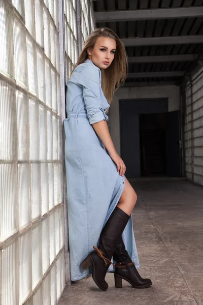 Portrait of beautiful woman in denim dress and boots — Stock Photo, Image