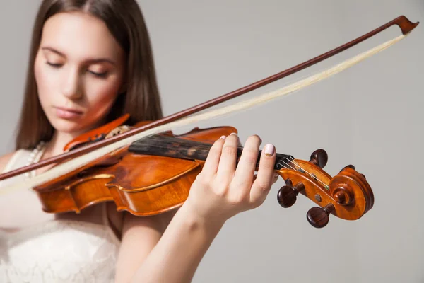 Close-up of woman playing violin with bow — Stock Photo, Image