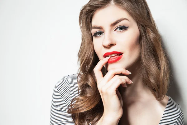 Close-up young brunette in striped body posing against of white wall — Stock Photo, Image