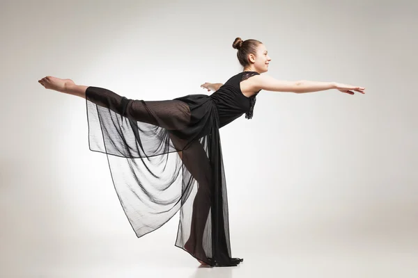 Young ballet dancer wearing black transparent dress dancing — Stock Photo, Image