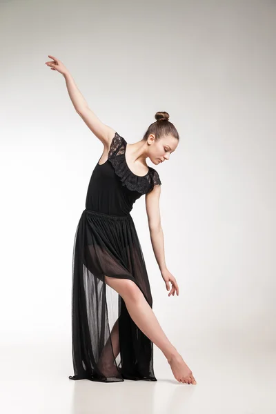 Young ballet dancer wearing black transparent dress dancing — Stock Photo, Image