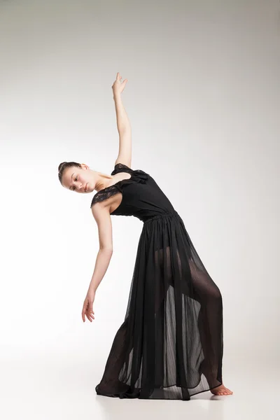 Young ballet dancer wearing black transparent dress dancing — Stock Photo, Image