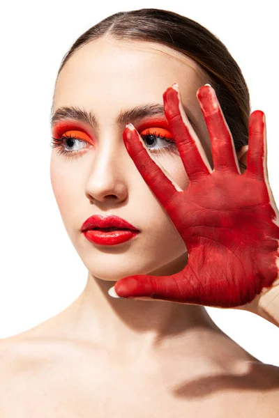 Woman with red makeup and painted hand — Stock Photo, Image