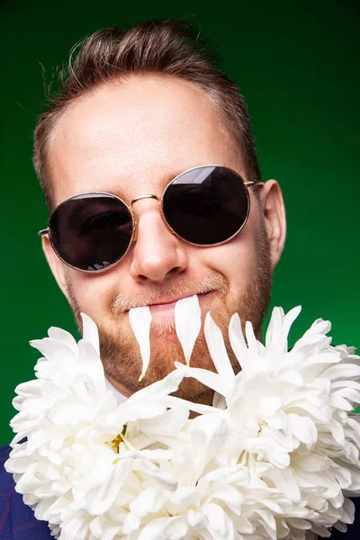 Stylish man in suit and with flowers on neck — Stock Photo, Image