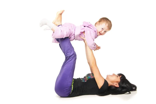 Mother with the baby doing exercises over white — Stock Photo, Image