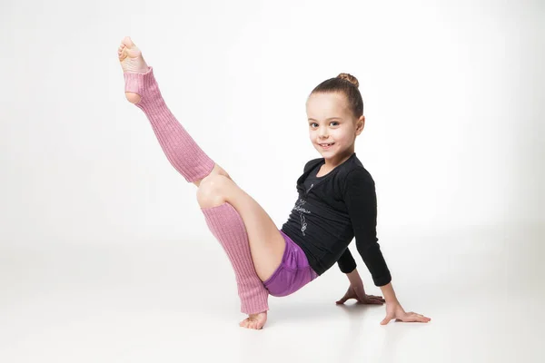 Całkiem mała dziewczynka robi Gimnastyka na białym tle — Zdjęcie stockowe