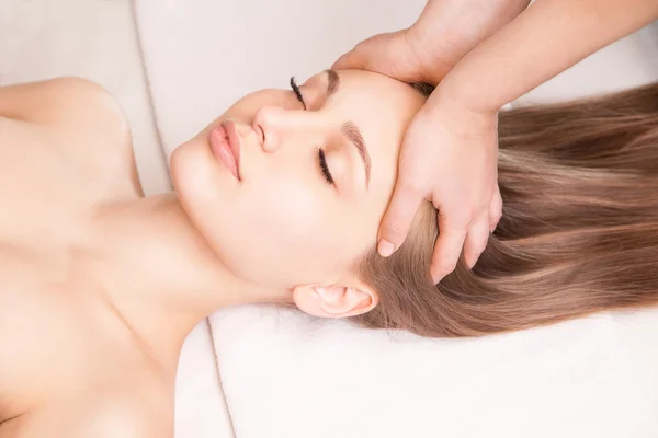 Young bright woman receiving head massage — Stock Photo, Image