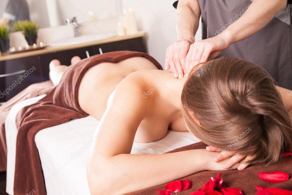 Masseur doing massage on woman body