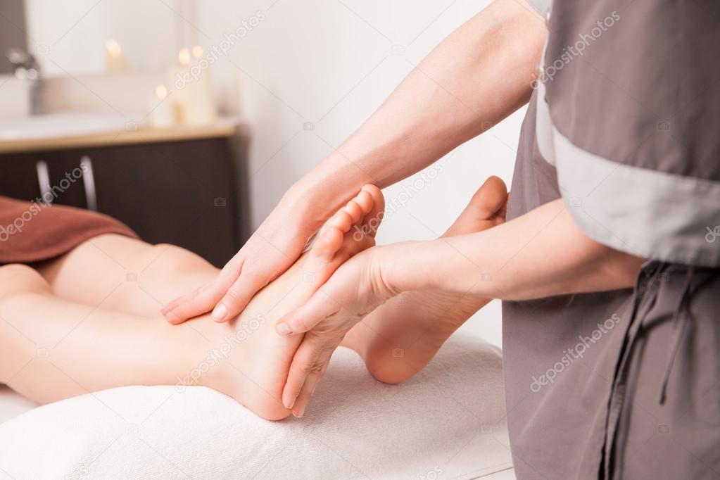Foot massage for a woman in luxury spa