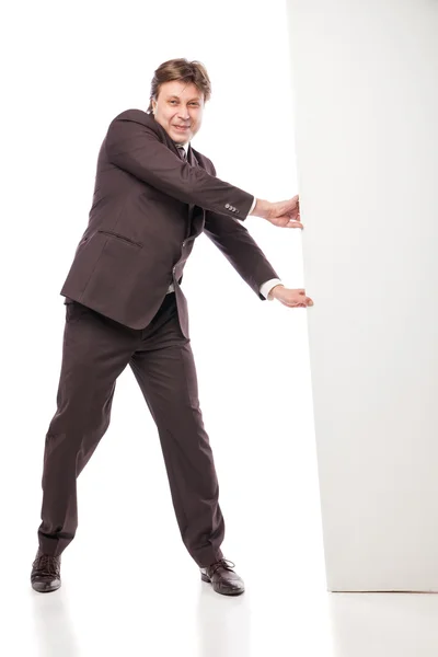 Business man holding empty board and pointing — Stock Photo, Image