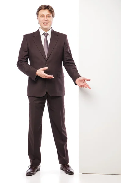 Business man holding empty board and pointing — Stock Photo, Image