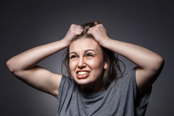 Angry woman screaming over dark grey — Stock Photo, Image