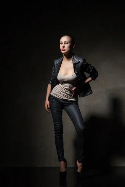 Attractive woman in black leather jacket and pants — Stock Photo, Image