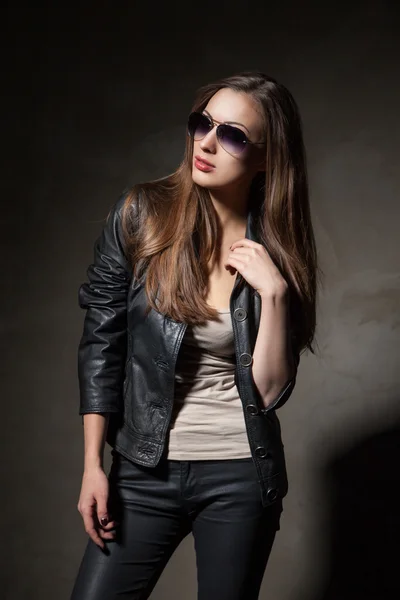 Attractive woman in black leather jacket and pants — Stock Photo, Image