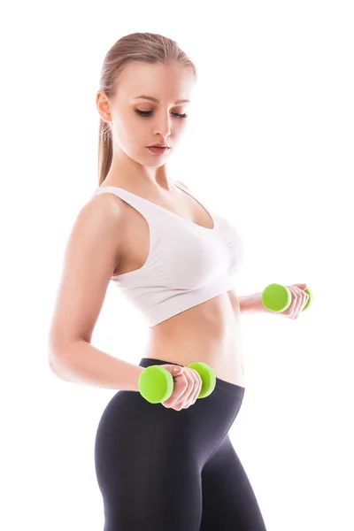 Athletic woman pumping up muscles with dumbbells — Stock Photo, Image