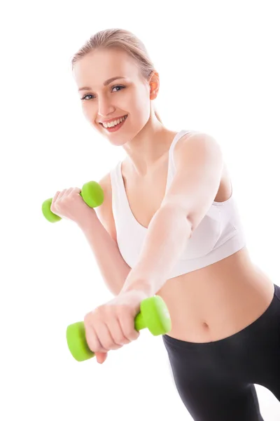 Athletic woman pumping up muscles with dumbbells — Stock Photo, Image