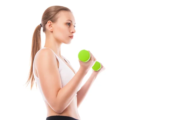 Athletic woman pumping up muscles with dumbbells — Stock Photo, Image