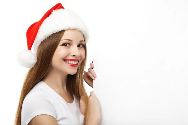 Kerstmis vrouw in Kerstman hoed wijzen leeg bord — Stockfoto