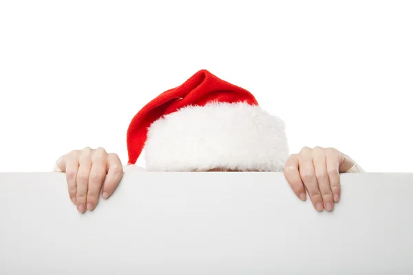 Boże Narodzenie kobieta w santa hat trzymając pusty pokładzie — Zdjęcie stockowe
