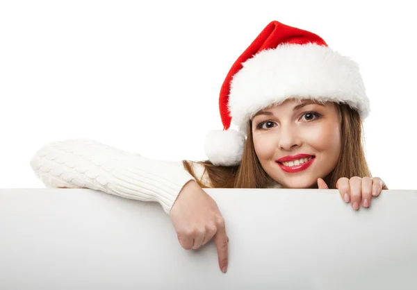 Mulher de Natal em santa chapéu apontando placa vazia — Fotografia de Stock