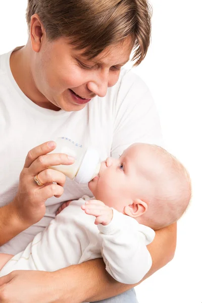 Young father holding and feeding her baby — Stock Photo, Image