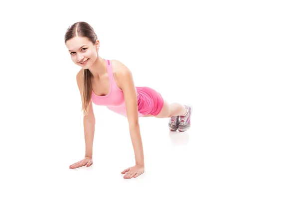 Young sporty woman doing exercises over white — Stock Photo, Image