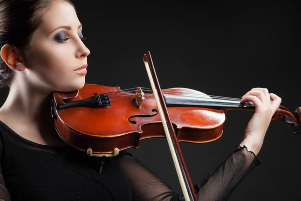 Beautiful young woman playing violin over black — Stock Photo, Image