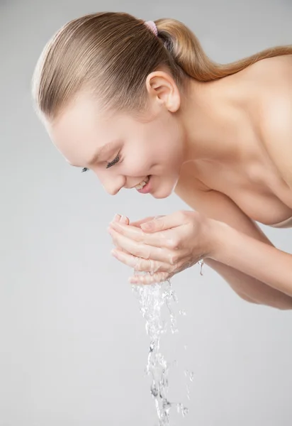 Beautiful woman washing her clean face with water — Stock Photo, Image