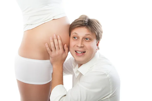 Husband listening to his wifes belly — Stock Photo, Image