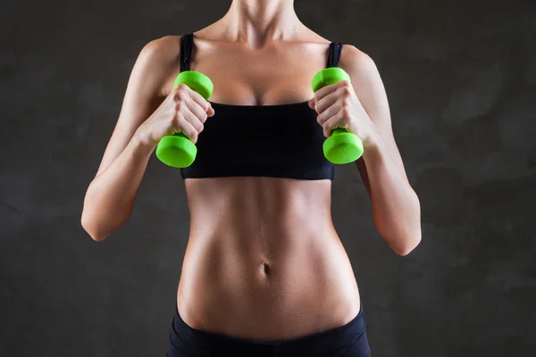 Body of young fit woman lifting dumbbells — Stock Photo, Image