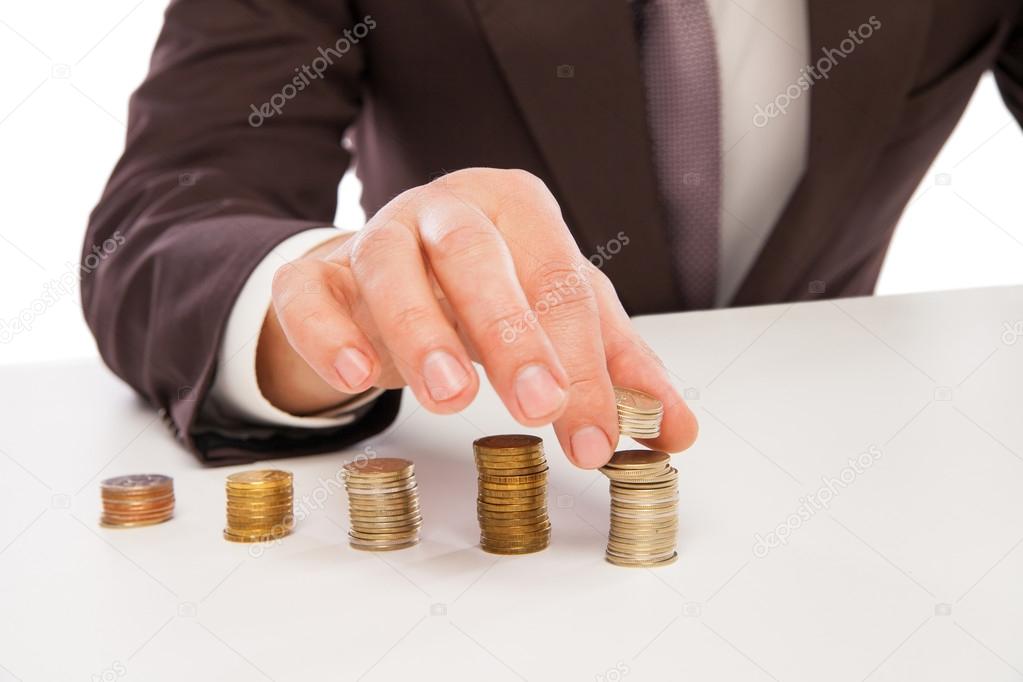 closeup shot of hands counting coins over white