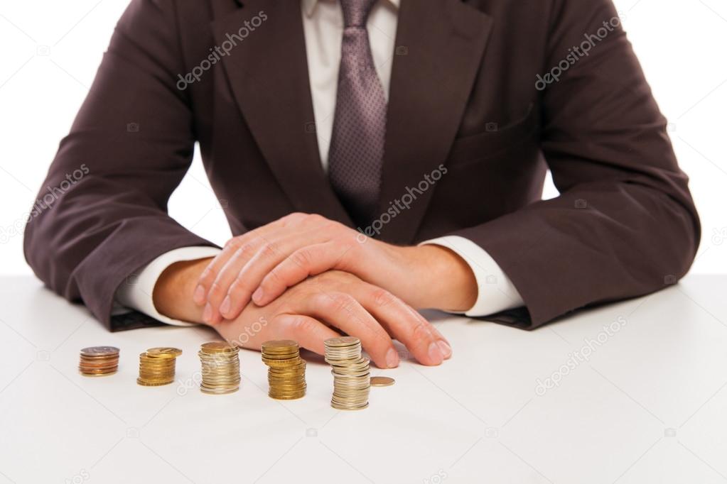 closeup shot of hands counting coins over white