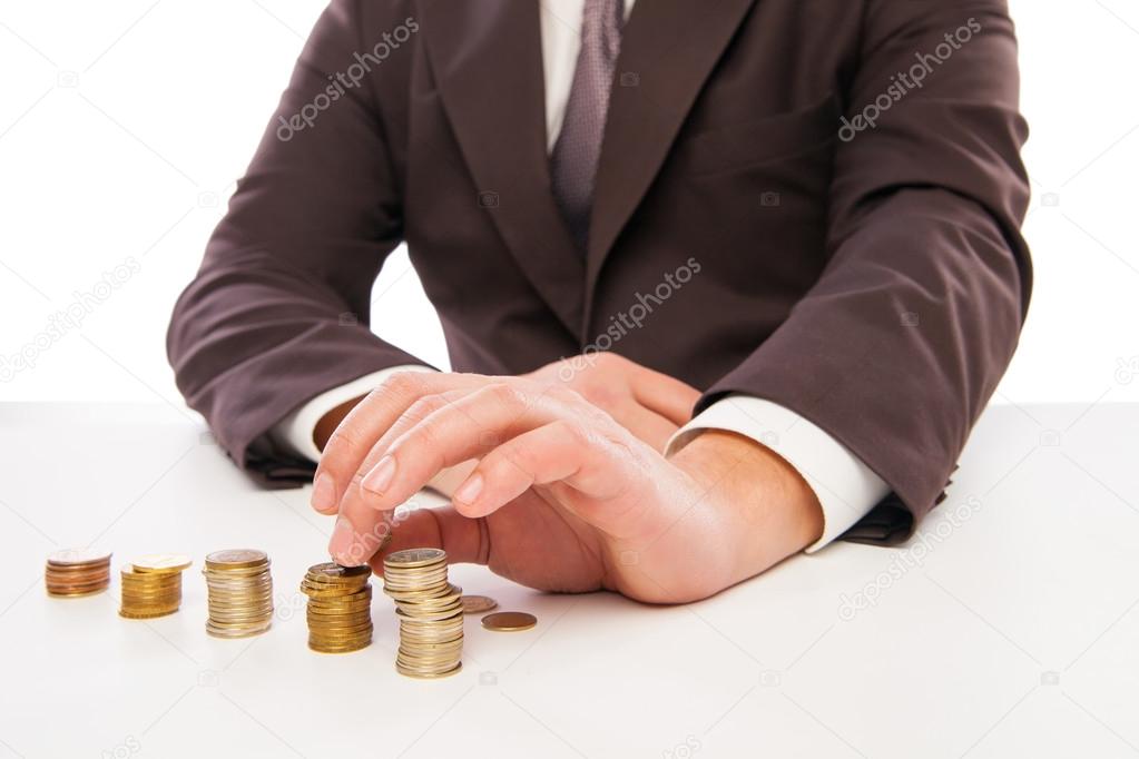 closeup shot of hands counting coins over white
