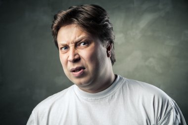 Man with disgusted expression over dark grey clipart