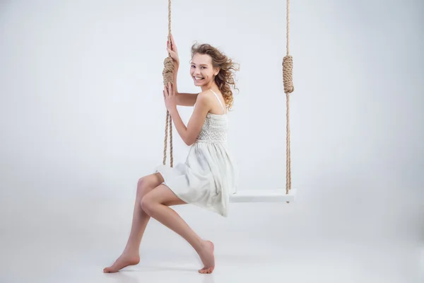 Beautiful  woman sitting on swing  isolated — Stock Photo, Image