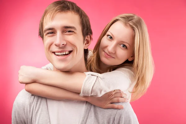 Smiling couple hugging, looking in the camera Stock Picture