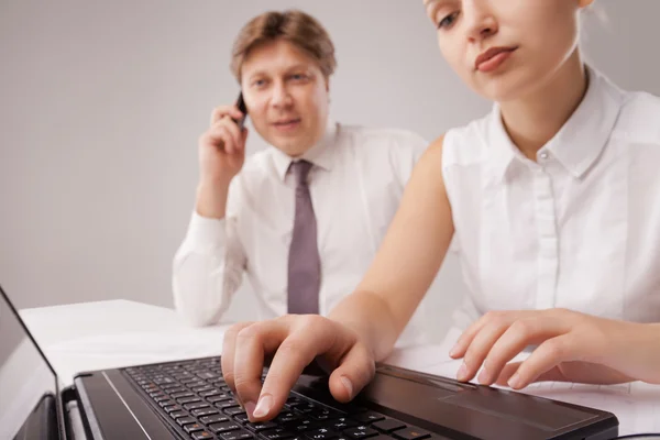 Coworkers working with laptop and cellphone — Stock Photo, Image