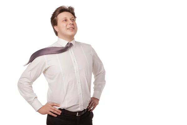 Joven hombre de negocios sonriendo con la corbata que sopla —  Fotos de Stock