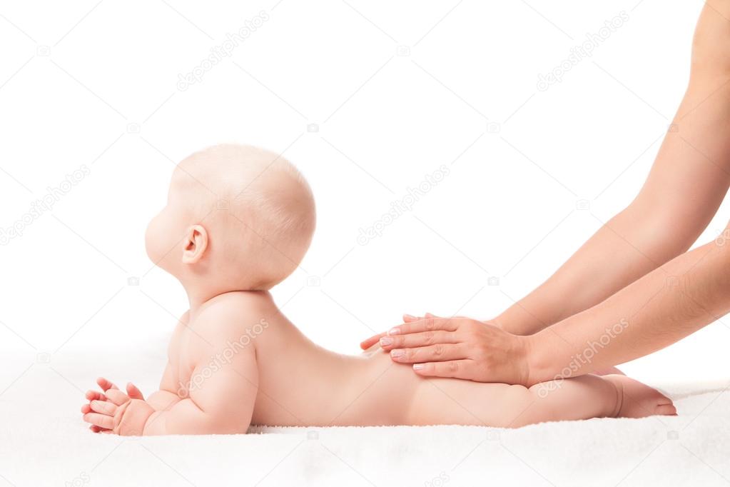 Cute baby lying. hands massaging his bottom
