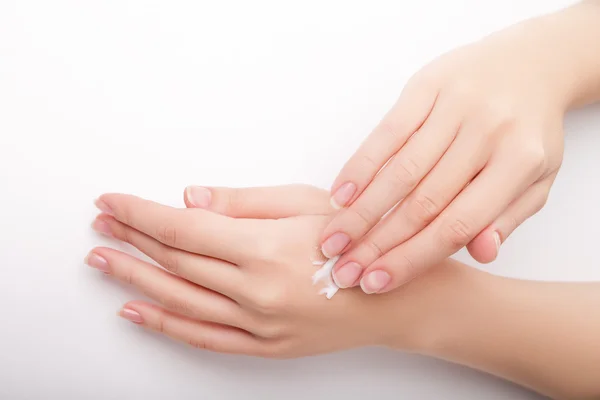 Beautiful young woman hands with cream. — Stock Photo, Image