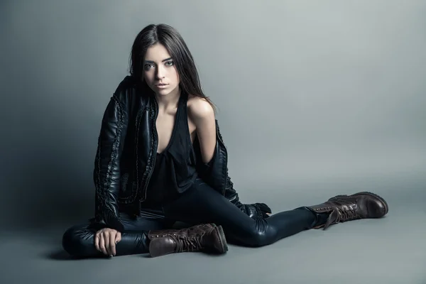 Fashion model wearing leather pants and jacket
