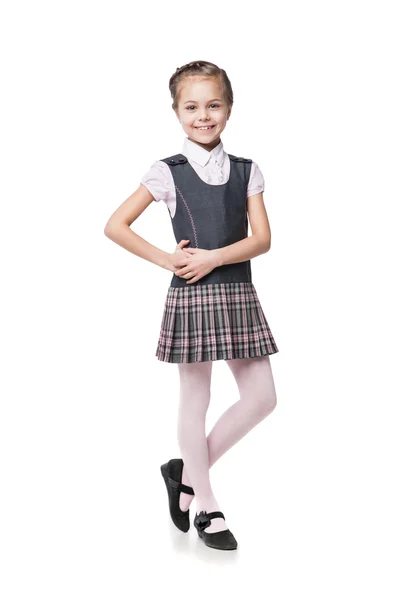 Vacker liten flicka i skoluniform isolerad på vit Stockbild