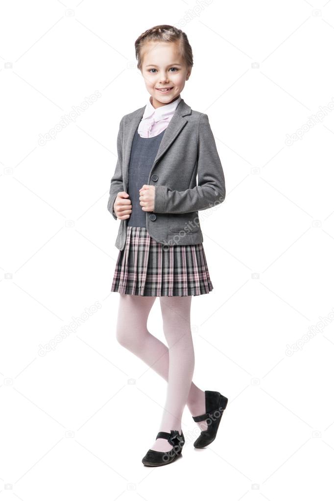 Beautiful little girl in school uniform isolated on white