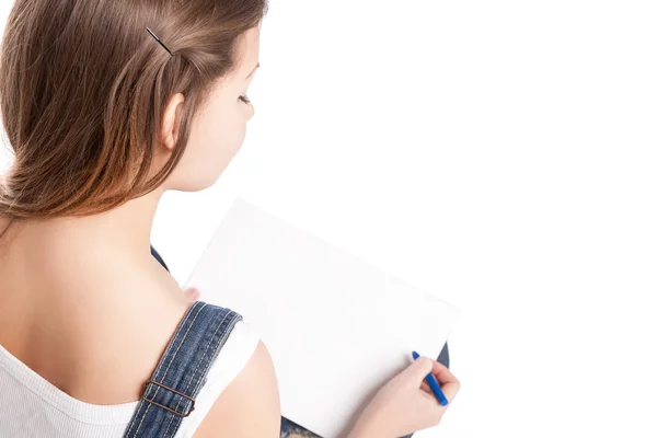 Mujer joven dibujando en su bloc de notas. Vista trasera — Foto de Stock