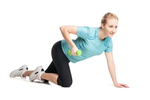 Athletic young woman works out with green dumbbells — Stock Photo, Image