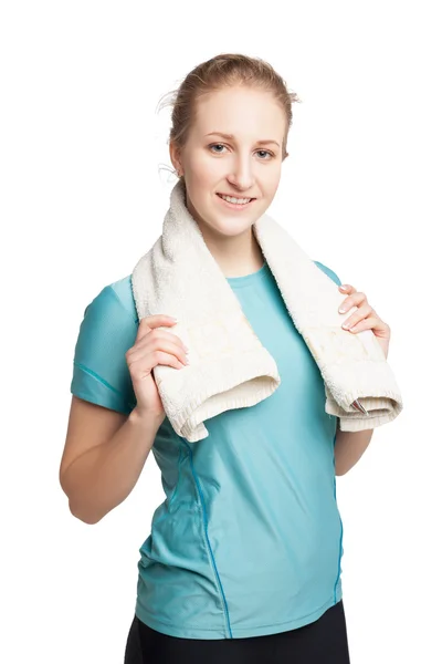 Sonriente modelo de fitness femenino feliz con una toalla mirando a la cámara Imagen de archivo