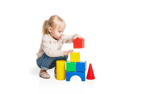 Baby girl building from toy blocks — Stock Photo, Image