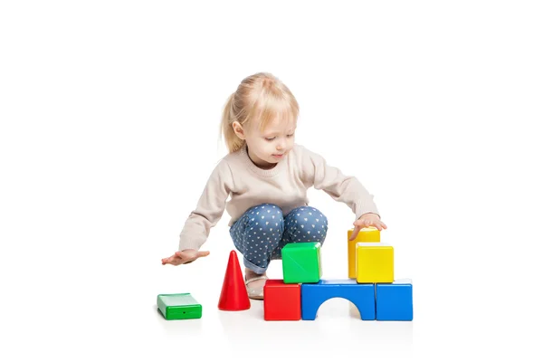 Baby girl building from toy blocks — Stock Photo, Image