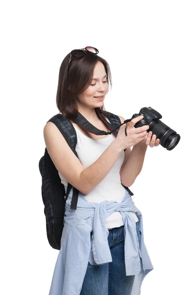 Young female tourist with backpack looking to her camera — Stock Photo, Image