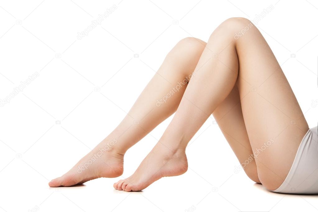 Close-up of young woman with beautiful legs lying 